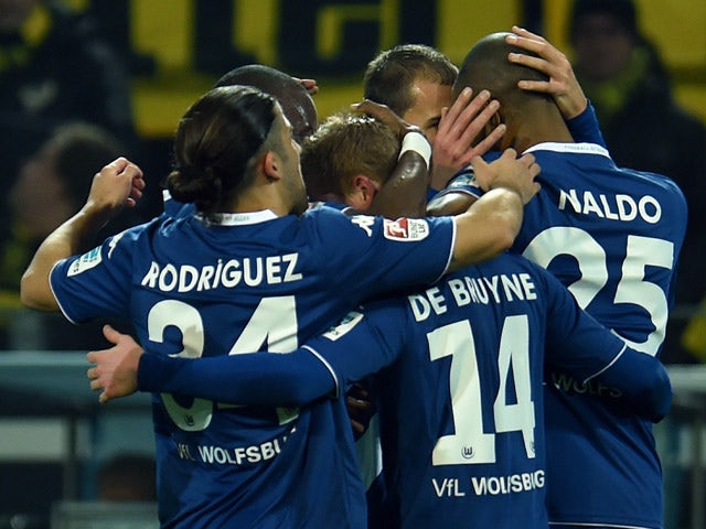 Wolfsburg's players celebrate during the German First division Bundesliga football match Borussia Dortmund v VfL Wolfsburg in Dortmund, Germany, on December 17, 2014