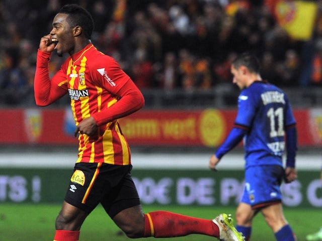Lens' French midfielder Wylan Cyprien (L) jubilates after scoring a goal during the French L1 football match Lens (RCL) vs Nice (OGCN) on December 19, 2014