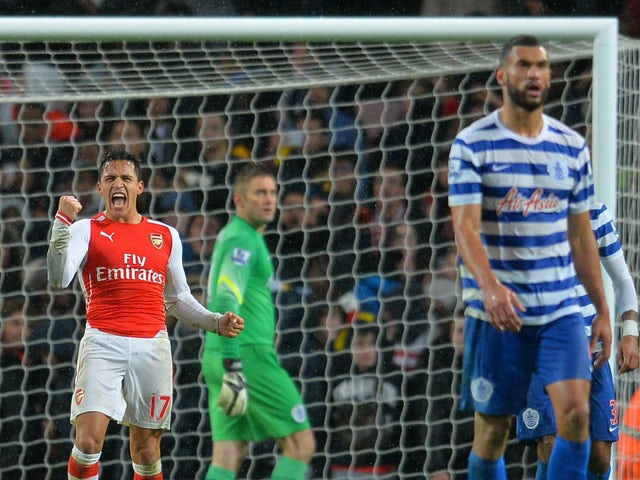 Arsenal's Chilean striker Alexis Sanchez celebrates after scoring the opening goal during the English Premier League football match between Arsenal and Queens Park Rangers at the Emirates Stadium in London on December 26, 2014