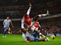 Rio Ferdinand of QPR tackles Danny Welbeck of Arsenal during the Barclays Premier League match between Arsenal and Queens Park Rangers at Emirates Stadium on December 26, 2014