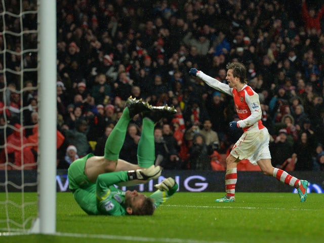 Arsenal's Czech midfielder Tomas Rosicky celebrates scoring their second goal during the English Premier League football match between Arsenal and Queens Park Rangers at the Emirates Stadium in London on December 26, 2014
