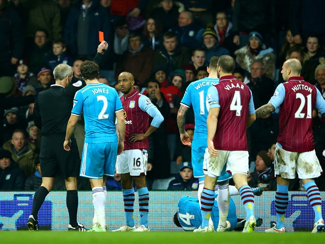 Fabian Delph of Aston Villa receives a red card from referee Martin Atkinson during the Barclays Premier League match between Aston Villa and Sunderland at Villa Park on December 28, 2014