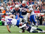 Scott Chandler #84 of the Buffalo Bills is tackled after catching a pass during the first quarter against the New England Patriots at Gillette Stadium on December 28, 2014