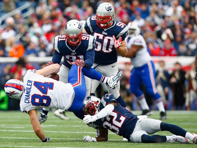 Scott Chandler #84 of the Buffalo Bills is tackled after catching a pass during the first quarter against the New England Patriots at Gillette Stadium on December 28, 2014