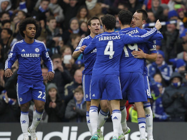 Chelsea's English defender John Terry celebrates scoring the opening goal with teammates during the English Premier League football match between Chelsea and West Ham United at Stamford Bridge in London on December 26, 2014