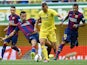 Denis Cheryshev of Villarreal is tackled by Sergio Busquets of Barcelona during the La Liga match between Villarreal CF and FC Barcelona at El Madrigal stadium on August 31, 2014
