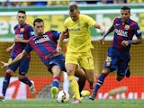 Denis Cheryshev of Villarreal is tackled by Sergio Busquets of Barcelona during the La Liga match between Villarreal CF and FC Barcelona at El Madrigal stadium on August 31, 2014