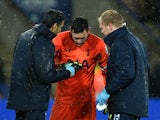 Hugo Lloris of Spurs receives treatment for an injury during the Barclays Premier League match against Leicester City on December 27, 2014