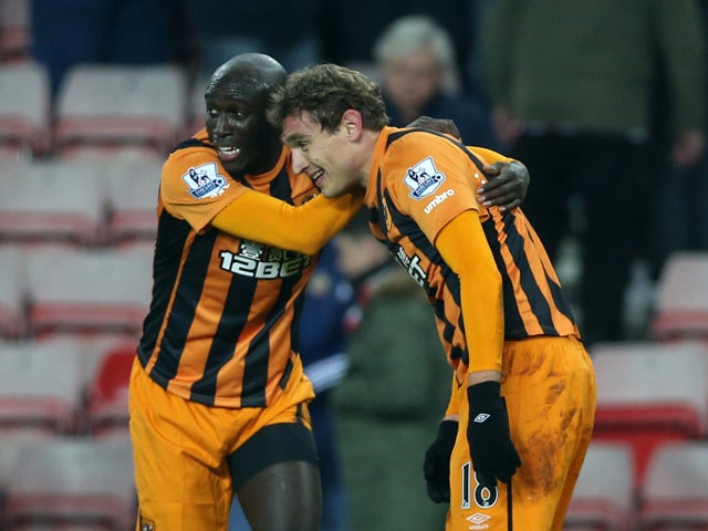 Hull City's Croatian striker Nikica Jelavic celebrates scoring their third goal with Hull City's Ivorian striker Yannick Sagbo during the English Premier League football match between Sunderland and Hull City at The Stadium of Light in Sunderland, north e