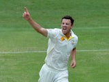 Josh Hazlewood of Australia celebrates taking the wicket of Cheteshwar Pujara of India during day four of the 2nd Test match between Australia and India at The Gabba on December 20, 2014