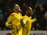 Raheem Sterling of Liverpool celebrates scoring the opening goal with Adam Lallana during the Barclays Premier League match between Burnley and Liverpool at Turf Moor on December 26, 2014