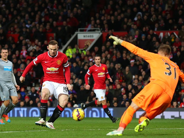 Wayne Rooney of Manchester United scores the first goal during the Barclays Premier League match between Manchester United and Newcastle United at Old Trafford on December 26, 2014