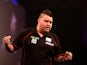 Michael Smith of England celebrates winning his first round match against Mensur Suljovic on December 22, 2014
