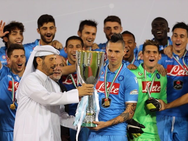 Qatar's Prime Minister, Sheikh Abdullah bin Nasser bin Khalifa al-Thani (L) presents Napoli's Slovak midfielder and captain Marek Hamsik (C) with Italian Super Cup trophy on December 22, 2014