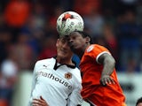 Nile Ranger of Blackpool in action with George Saville of Wolverhampton Wanderers during the Sky Bet Championship match at Bloomfield Road on September 13, 2014