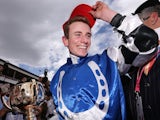 Jockey Ryan Moore celebrates with the trophy after winning on Protectionist in race 7 the Emirates Melbourne Cup on November 4, 2014