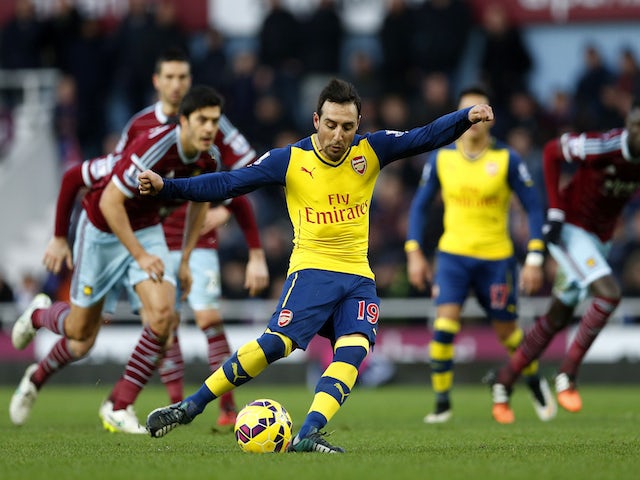 Santi Cazorla of Arsenal scores the opening goal from the penalty spot during the Barclays Premier League match against West Ham United on December 28, 2014