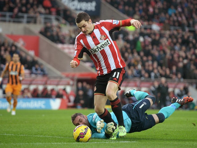 Adam Johnson of Sunderland rounds goalkeeper Allan McGregor of Hull City to score the opening goal following a poor back pass during the Barclays Premier League match between Sunderland and Hull City at the Stadium of Light on December 26, 2014