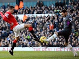 Robin van Persie of Manchester United has his attempt on goal saved by goalkeeper Hugo Lloris of Spurs during the Barclays Premier League match between Tottenham Hotspur and Manchester United at White Hart Lane on December 28, 2014