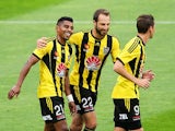 Roy Krishna of the Phoenix is congratulated on his goal by teammates Andrew Durante and Nathan Burns during the round 13 A-League match between the Wellington Phoenix and the Western Sydney Wanderers at Westpac Stadium on December 28, 2014