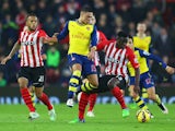 Alex Oxlade-Chamberlain of Arsenal takes on Victor Wanyama and Ryan Bertrand of Southampton during the Barclays Premier League match between Southampton and Arsenal at St Mary's Stadium on January 1, 2015