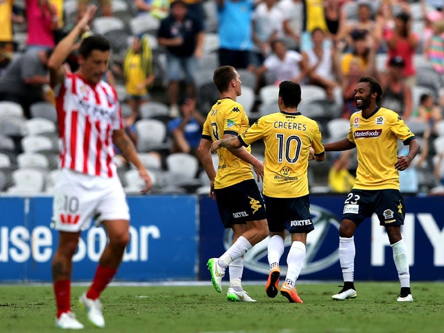 Mariners players Mitchell Duke, Isaka Cernak, Glen Trifiro and Anthony Caceres celebrate a goal with Melbourne City looking dejected in frame during the round 15 A-League match between the Central Coast Mariners and Melbourne City FC at Central Coast Stad