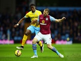 Wilfried Zaha of Crystal Palace and Ron Vlaar of Aston Villa battle for the ball during the Barclays Premier League match between Aston Villa and Crystal Palace at Villa Park on January 1, 2015