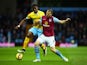 Wilfried Zaha of Crystal Palace and Ron Vlaar of Aston Villa battle for the ball during the Barclays Premier League match between Aston Villa and Crystal Palace at Villa Park on January 1, 2015