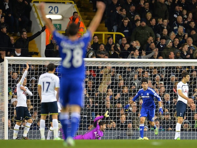Chelsea's Brazilian-born Spanish striker Diego Costa (2nd R) turns to celebrate after scoring the opening goal as Tottenham's players appeal for an offside during the English Premier League on January 1, 2015