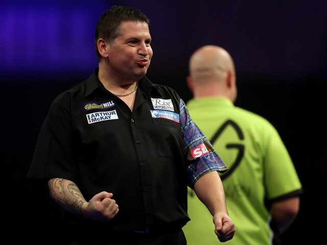 Gary Anderson of Scotland celebrates winning a set during his semi final match against Michael van Gerwen of the Netherlands on day thirteen of the 2015 William Hill PDC World Darts Championships at Alexandra Palace on January 3, 201