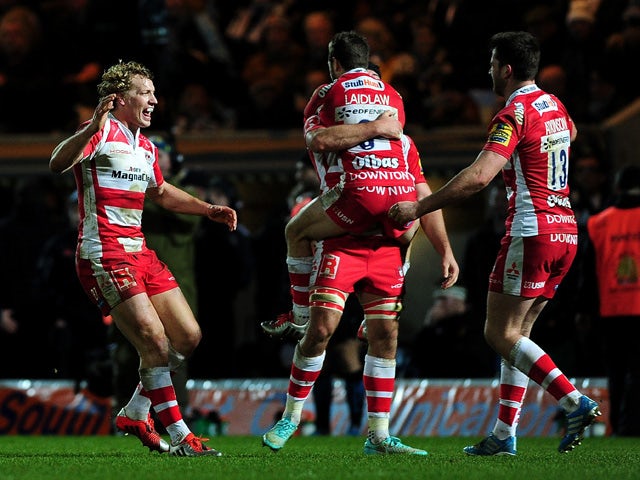 Billy Twelvetress of Gloucester runs to celebrate with Mark Atkinson of Gloucester at the final whistle during the Aviva Premiership match between Exeter Chiefs and Gloucester Rugby at Sandy Park on January 3, 2015