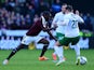 Morgaro Gomis of Hearts is tackled by Danny Handling of Hibernian during the Scottish Championship match between Heart of Midlothian F.C. and Hibernian F.C. at Tynecastle Stadium on January 3, 2015