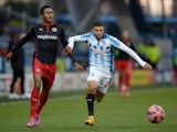 Nahki Wells of Huddersfield gets past Jordan Obita of Reading during the FA Cup Third Round match between Huddersfield Town and Reading at Galpharm Stadium on January 3, 2015