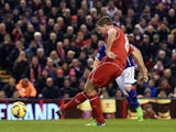 Liverpool's English midfielder Steven Gerrard scores his team's first goal from a penalty during the English Premier League football match between Liverpool and Leicester City at Anfield in Liverpool, north west England, on January 1, 2015