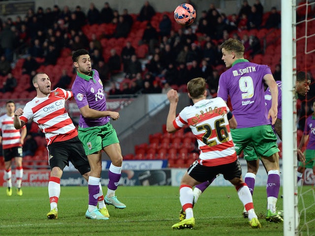 Luke McCullough (L) of Doncaster Rovers shoots to score during the FA Cup Third Round match against Bristol City on January 3, 2015