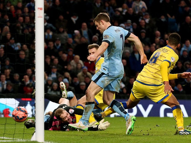 James Milner of Manchester City scores his team's second goal to take a 2-1 lead during the FA Cup Third Round match between Manchester City and Sheffield Wednesday at Etihad Stadium on January 4, 2015