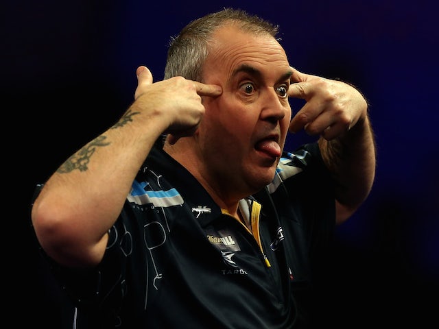 Phil Taylor of England reacts after winning a set during his quarter final match against Vincent van der Voort of the Netherlands on day twelve of the 2015 World Championships on January 2, 2015