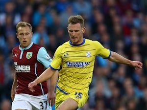 Tom Lees of Sheffield Wednesday in action with Scott Arfield of Burnley during the Capital One Cup Second Round match between Burnley and Sheffield Wednesday at Turf Moor on August 26, 2014