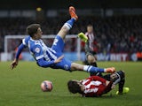 Solly March of Brighton & Hove Albion is tackled by Tommy Smith of Brentford during the FA Cup Third Round match on January 3, 2015
