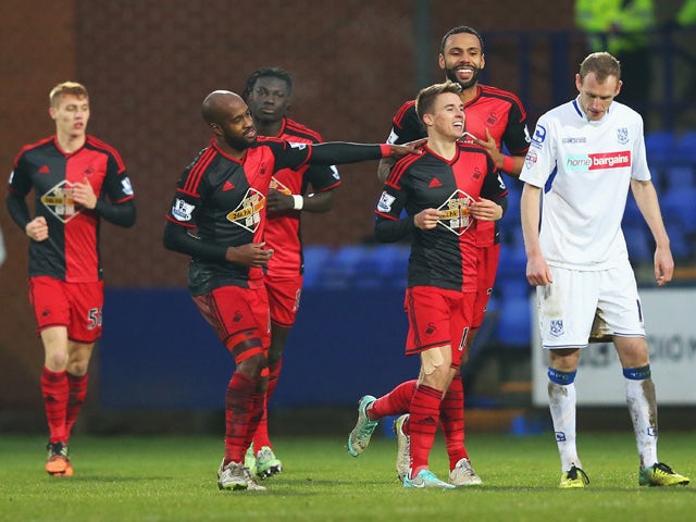 Tommy Carroll of Swansea City celebrates scoring his team's second goal with team mates during the FA Cup Third Round match between Tranmere Rovers and Swansea City at Prenton Park on January 3, 2015