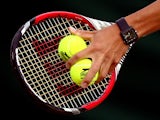 Detail shot of Kei Nishikori of Japan's racquet and slazenger tennis balls during his Gentlemen's Singles third round match against Simone Bolelli of Italy on day six of the Wimbledon Lawn Tennis Championships at the All England Lawn Tennis and Croquet Cl