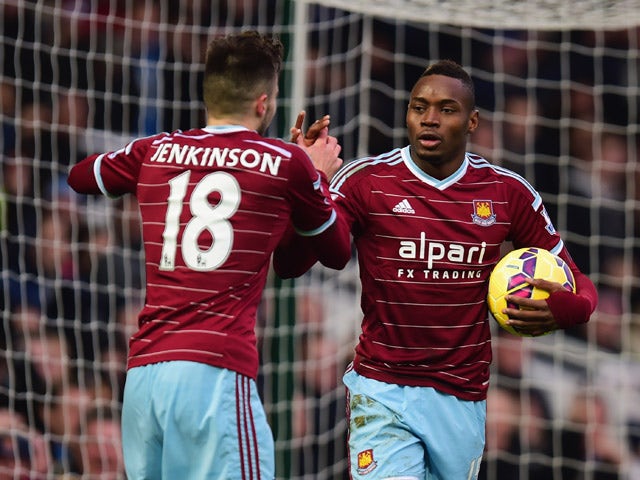 Diafra Sakho of West Ham United celebrates with Carl Jenkinson as he scores their first goal during the Barclays Premier League match between West Ham United and West Bromwich Albion at Boleyn Ground on January 1, 2015