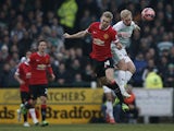 Manchester United's Scottish midfielder Darren Fletcher and Yeovil Town's English midfielder Simon Gillett contest a high ball during the English FA Cup third round football match between Yeovil Town and Manchester United at Huish Park in Yeovil, Somerset