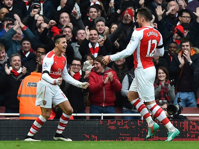 Arsenal's Chilean striker Alexis Sanchez celebrates with Arsenal's French striker Olivier Giroud after scoring their second goal during the English Premier League football match between Arsenal and Stoke City at the Emirates Stadium in London on January 1