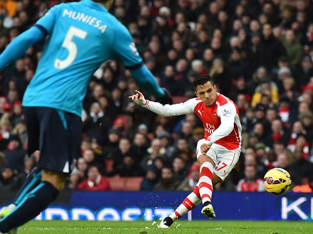 Arsenal's Chilean striker Alexis Sanchez shoots to score their third goal from a freekick during the English Premier League football match between Arsenal and Stoke City at the Emirates Stadium in London on January 11, 2015