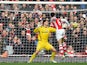 Arsenal's French defender Laurent Koscielny heads the opening goal past Stoke City's Bosnian goalkeeper Asmir Begovic during the English Premier League football match between Arsenal and Stoke City at the Emirates Stadium in London on January 11, 2015