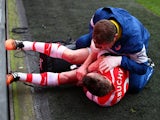 Mathieu Debuchy of Arsenal receives treatment for an injury before being stretchered off during the Barclays Premier League match between Arsenal and Stoke City at Emirates Stadium on January 11, 2015