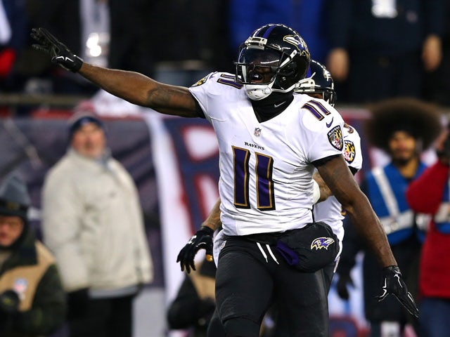 Kamar Aiken #11 of the Baltimore Ravens celebrates after scoring a touchdown in the first quarter against the New England Patriots during the 2014 AFC Divisional Playoffs game at Gillette Stadium on January 10, 2015
