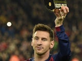 Barcelona's Argentinian forward Lionel Messi holds up a trophy after being honored by the Spanish Professional Football League (LFP) for breaking the La Liga goal scoring record before the Spanish league football match FC Barcelona vs Club Atletico de Mad