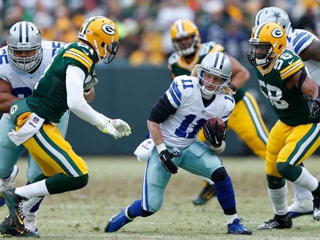 Cole Beasley #11 of the Dallas Cowboys carries the football against Sam Barrington #58 of the Green Bay Packers during the 2015 NFC Divisional Playoff game at Lambeau Field on January 11, 2015